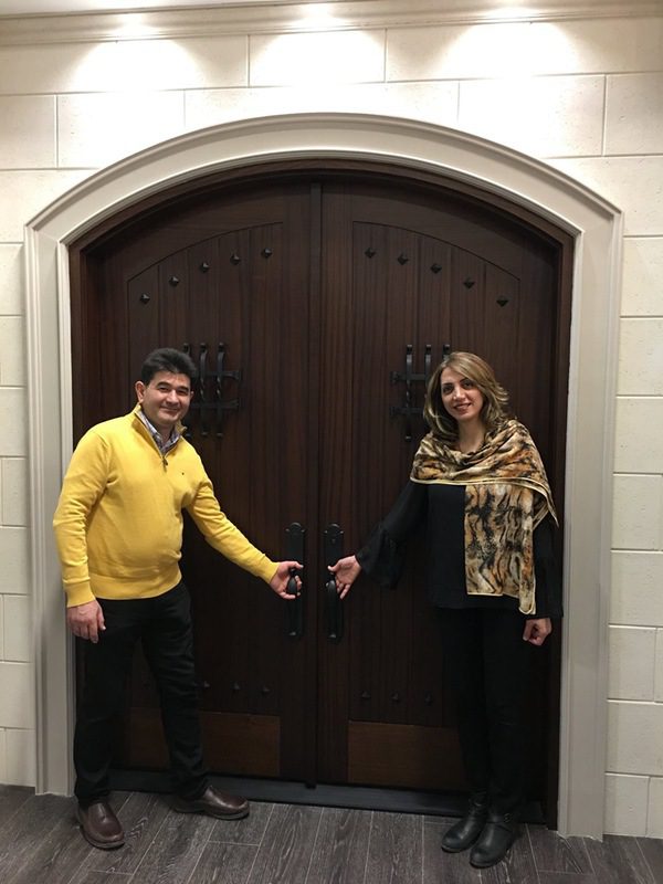 Two people standing at each door