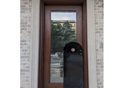 Modern Medium Brown Wood Exterior Door and decorative black panel