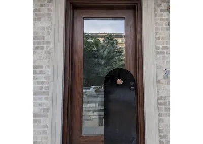 Modern Medium Brown Wood Exterior Door and decorative black panel