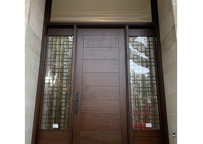 Modern Flat Dark Brown Wood Exterior Door with sidelits, decorative iron transom and horizontal grooves