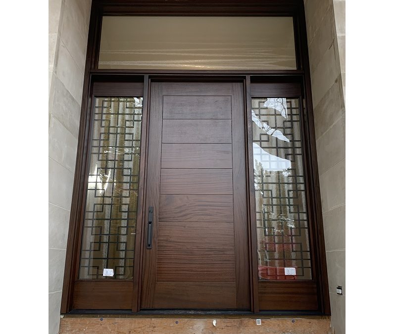 Modern Flat Dark Brown Wood Exterior Door with sidelits, decorative iron transom and horizontal grooves