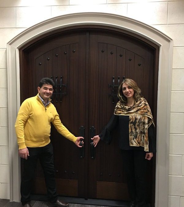 Two people standing at door