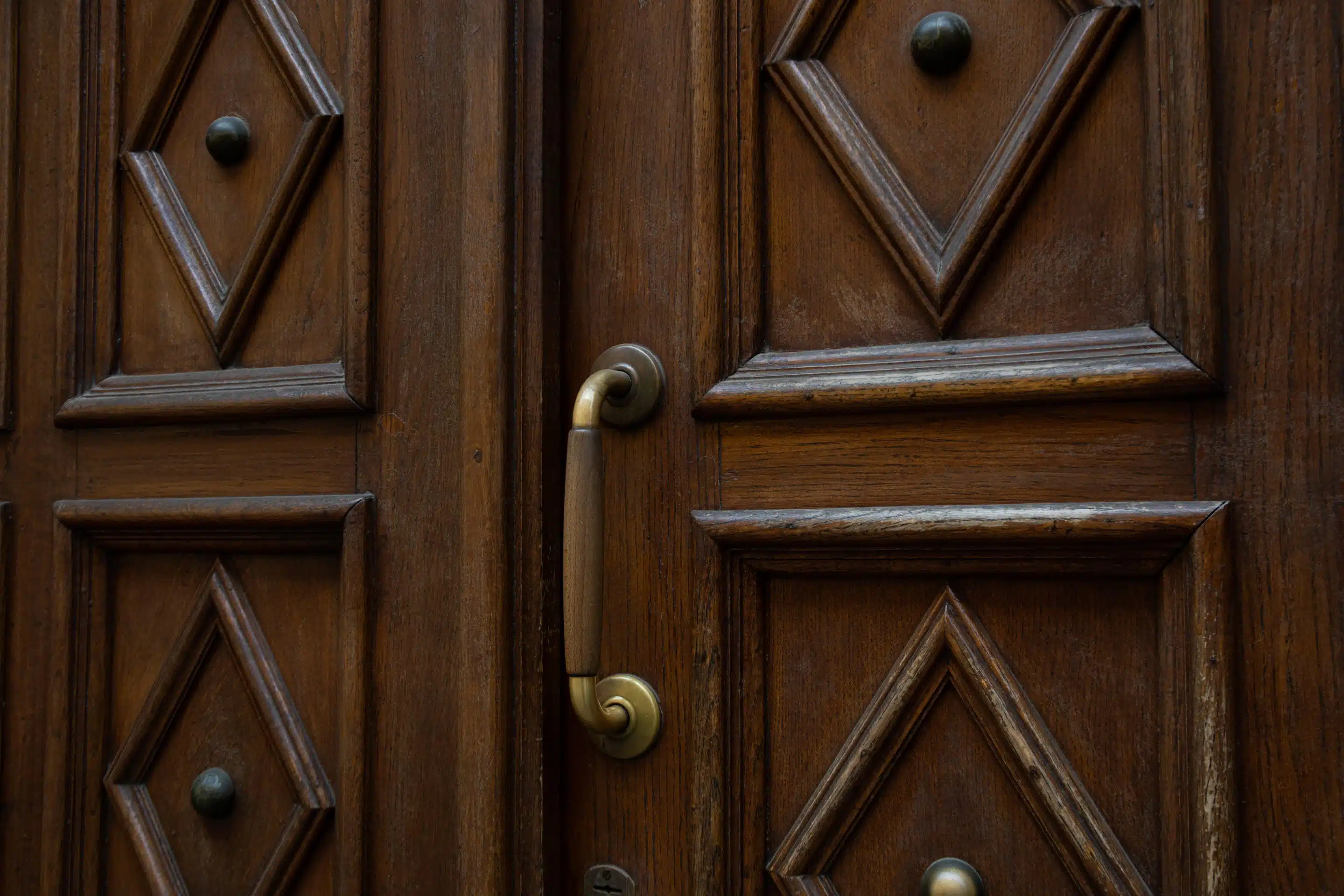 Close-up view of an old massive wooden door double exterior doors